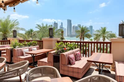Outdoor seating at Grand Zor Restaurant Dubai with skyline view.