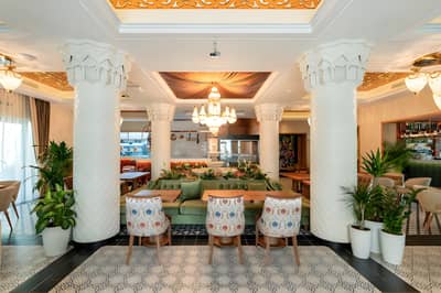 Elegant interior of Grand Zor Restaurant Dubai with ornate columns.
