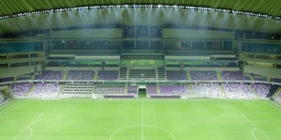 Empty Hazza Bin Zayed Stadium with green field, Al Ain.