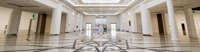 Spacious ADNEC Centre Al Ain lobby with geometric floor design.