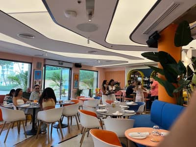 Peaches & Cream Beach Restaurant Dubai, vibrant interior with diners and bar.