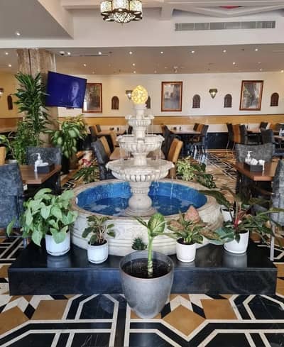 Elegant interior with fountain at Al Bait Al Shami, Dubai restaurant.