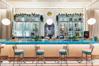 Gaia Dubai bar with turquoise counter and elegant decor.