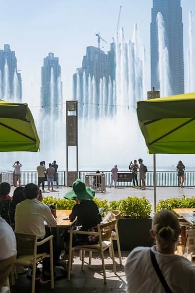 Diners at Social House Restaurant overlooking Dubai fountain show.