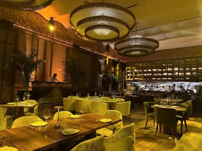 Elegant dining area at Baoli Restaurant Dubai with warm lighting.