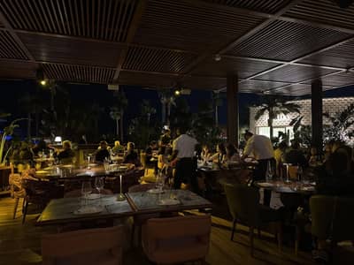 Evening dining at Baoli Restaurant Dubai with patrons and waitstaff.