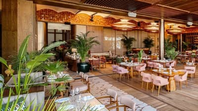 Elegant dining area at Baoli Restaurant Dubai with lush greenery.
