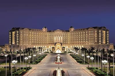 The Ritz Carlton Riyadh illuminated at night, grand entrance view.