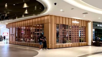 Social House Restaurant Dubai exterior with wooden facade and large windows.