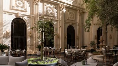 Elegant terrace at The Ritz Carlton Riyadh with seating and greenery.