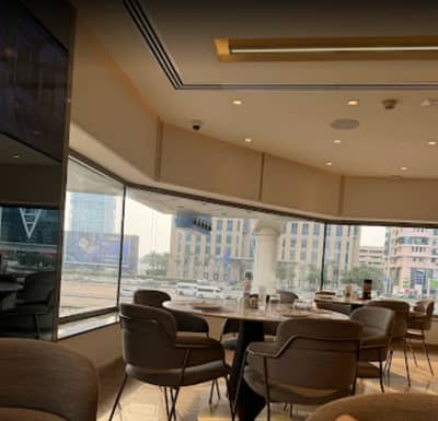 Interior of Al Safadi Restaurant DIFC, Dubai with city view.