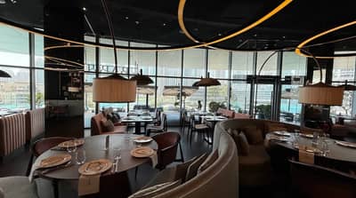 Elegant dining area at Babel Dubai Restaurant Downtown, with city view.