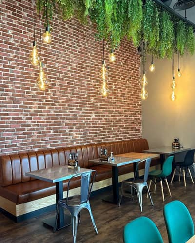 Swiss Butter Le Mall Jeddah, cozy seating with hanging lights and greenery.