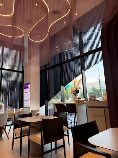Modern interior of Myra Cafe Jeddah with stylish lighting and seating.