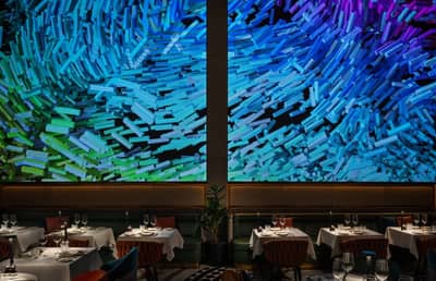 Zenon Restaurant Dubai, elegant dining area with vibrant abstract wall art.