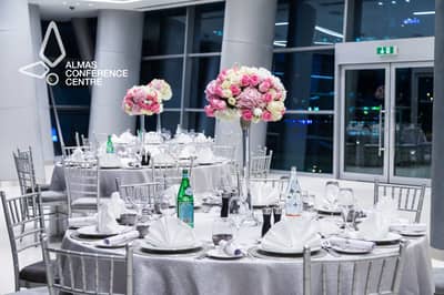 Sophisticated table arrangement with floral centerpieces at Almas Conference Centre, Dubai.
