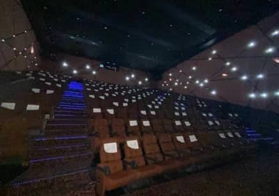 Novo Cinemas The Pearl Doha auditorium with illuminated seats and stairs.