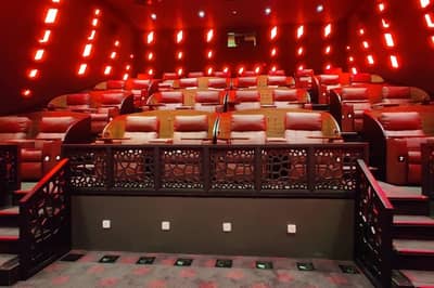 Luxurious seating at Novo Cinemas Msheireb Doha with red lighting.