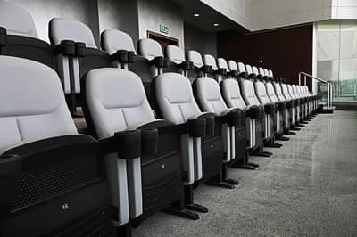 Abdullah Bin Khalifa Stadium seating area with gray chairs, Doha.