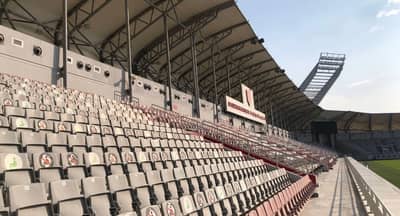 Empty stands at Abdullah Bin Khalifa Stadium, Doha under clear sky.