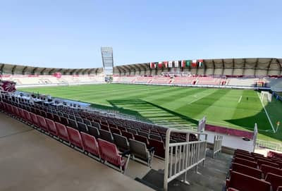 Abdullah Bin Khalifa Stadium, empty seats, green field, Doha.