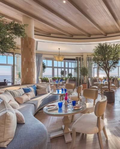 Elegant seating area in Yamaz Restaurant, Manama with sea view.