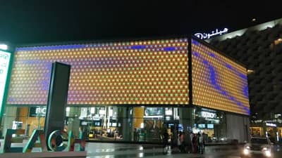 Reel Cinemas at Dubai Marina Mall illuminated at night.