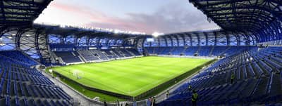 Al Nasr Al Maktoum Stadium in Dubai, empty with blue seats.