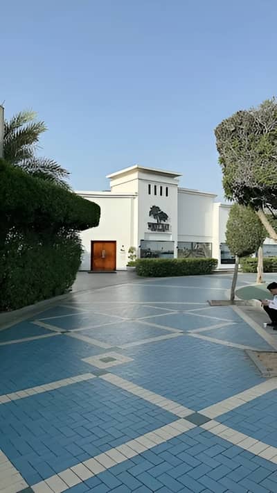 West Bay Lounge entrance with blue tiled path, Abu Dhabi.