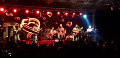 Band performing on stage at Regency Hall Doha with heart lights.
