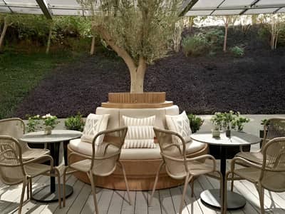 Patio seating with tree centerpiece at Twisted Olive, Doha.