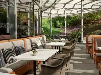 Shaded patio seating at Twisted Olive & Naama’s Garden, Doha.