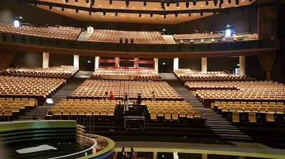 Empty seating inside National Theatre Abu Dhabi, spacious and well-lit.