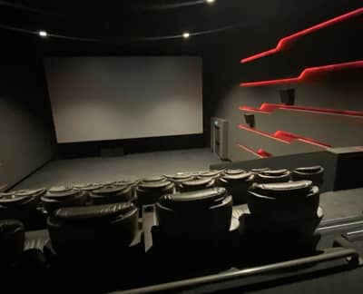 Empty theater with red accents, Empire Cinema Al Ahsa Al Hofuf.