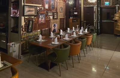 Elegant dining setup at Tanatan Dubai with artistic wall decor.