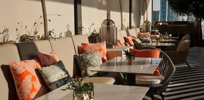 Outdoor seating at Do Tell Bahrain, Manama with colorful cushions.