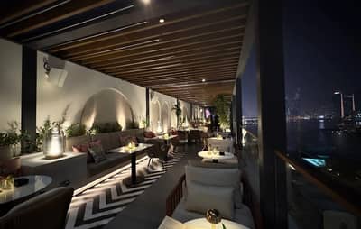 Elegant rooftop seating at Do Tell Bahrain, Manama, with city view.
