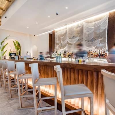 Elegant bar interior at Nammos Dubai with modern decor.