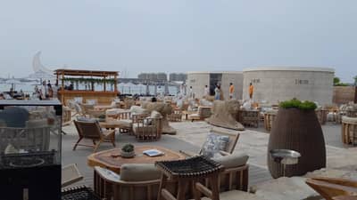 Nammos Dubai outdoor seating with sea view and luxury decor.