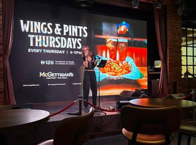 McGettigan's Factory The Palm stage with performer and event screen.