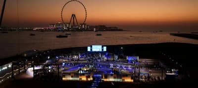 Evening event setup at Skydive Dubai, Dubai, UAE with Ferris wheel in background.