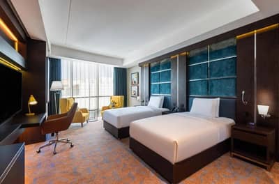 Modern guest room with twin beds at Holiday Inn Riyadh al Malaz, Riyadh.