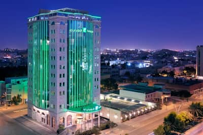 Illuminated building exterior at Holiday Inn Riyadh al Malaz by IHG, Riyadh, Saudi Arabia
