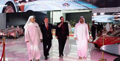 People walking in luxury car showroom at Aureum Club, Dubai, UAE