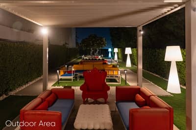 Outdoor seating area with colorful furniture at Aureum Club, Dubai, UAE