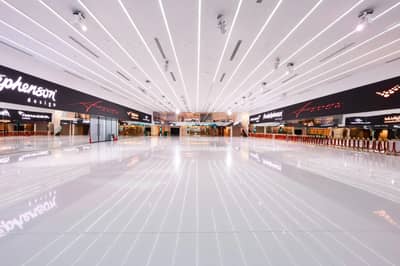Spacious, modern interior with reflective flooring at Aureum Club, Dubai, UAE.