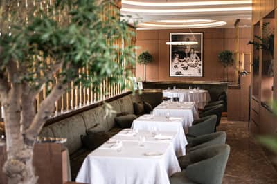 Elegant dining area with white tablecloths at LaFamiglia Dubai, Dubai, UAE