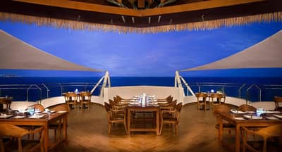 Elegant dining area overlooking the sea at Banana Island Resort Doha By Anantara.