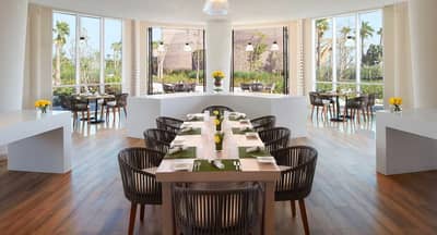 Elegant dining area with large windows at Banana Island Resort Doha By Anantara.