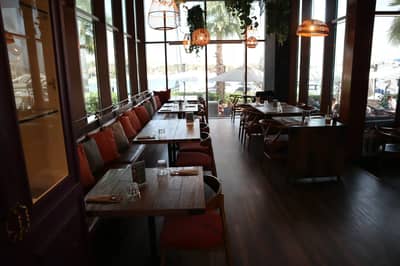 Cozy dining area with wooden tables at Ella's Eatery Restaurant Dubai, UAE